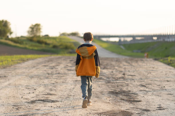 istock Young Boy Walking near the Forest 1494571086