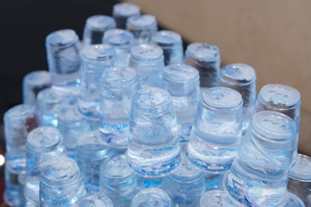 istock Stacked Layers of Packaged Mineral Water Cups on a Table in Close-up 1494571211