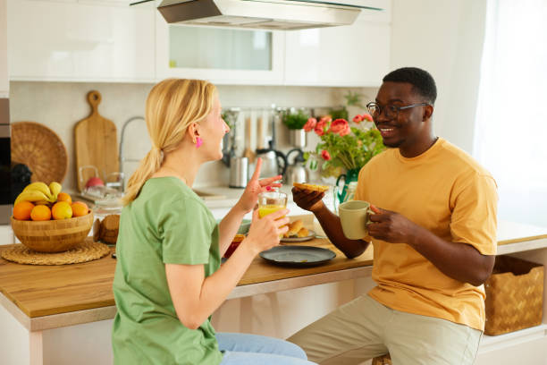 istock Multiracial couple enjoying breakfast together at home 1494573885