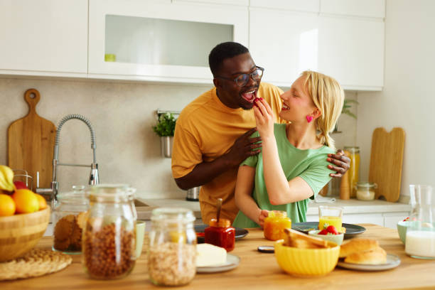 istock Multiracial couple enjoying breakfast together at home 1494574499