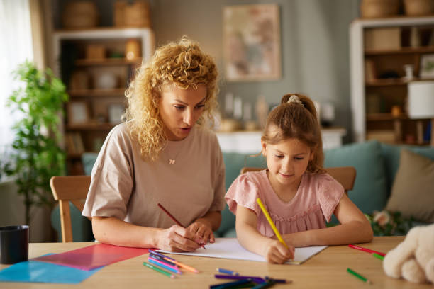 istock Mother and daughter drawing together at home 1494574862