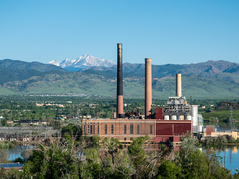 Smoke stacks of the decommissioned coal fired generation plant, now converted to gas. Boulder, Colorado. Long's Peak behind.