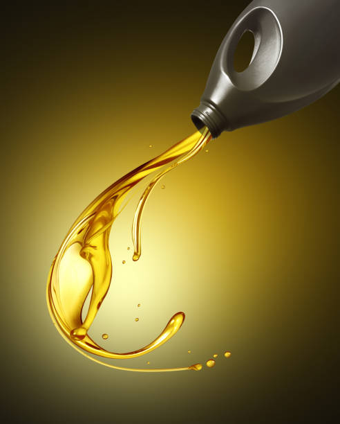 istock Splashes of engine oil pouring from a plastic bottle in the dark 1494575740