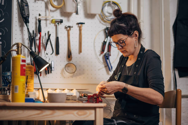 istock Woman making handmade jewelry in her workshop 1494576861