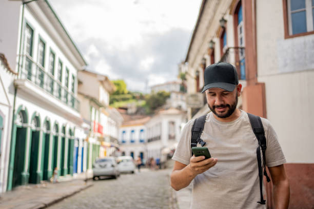 istock Tourist using smartphone in historic city 1494576879