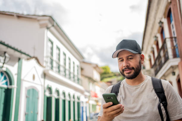 istock Tourist using smartphone in historic city 1494578160