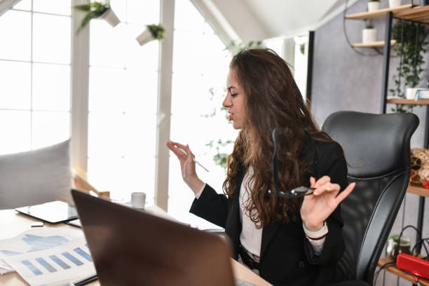 istock Businesswoman Slowly Analyzing Graphic Charts While Having Video Conference With Business Clients 1494578278