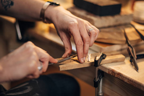 istock An unrecognizable female blacksmith makes jewelry, uses a tool, a file for sharpening 1494578661