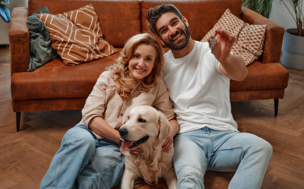 istock Couple with dog at home 1494578665