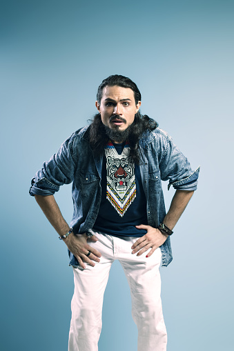 Portrait of a Brazilian wearing a button-up shirt and jeans, with his hands on his hips, looking forward in surprise - Belém - Pará - Brazil