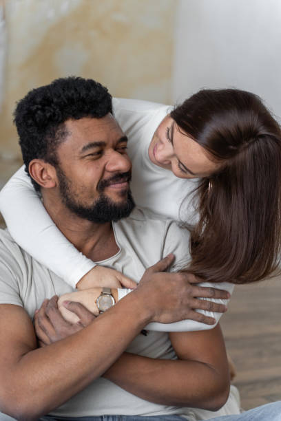 istock Multiethnic American couple embracing at home. 1494582159
