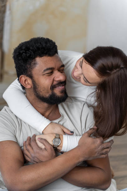 istock Multiethnic American couple embracing at home. 1494582166