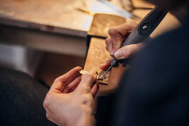 istock A woman uses a polisher while working on a new jewelry collection in a workshop 1494582263