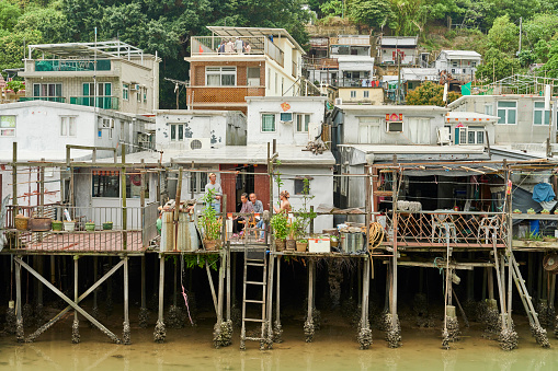 Hong Kong, April 02, 2023: a family enjoy free time on the terrace of their house on stilt in Tai O, a fishing village in Lantau Island.