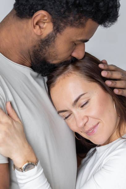 istock Multiethnic couple embracing at home. 1494582782