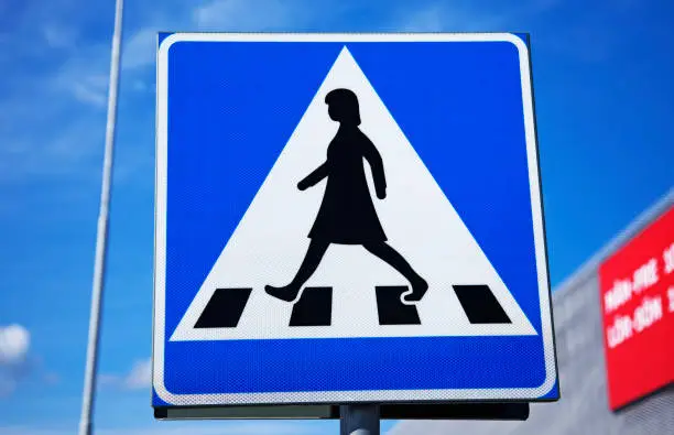 traffic sign for pedestrian crossing with female figure