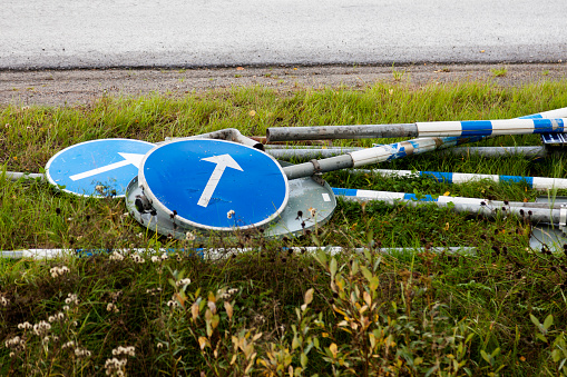 road signs lying down in the grass for mounting