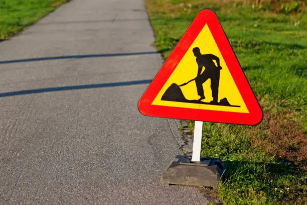 traffic sign depicting man working with roads