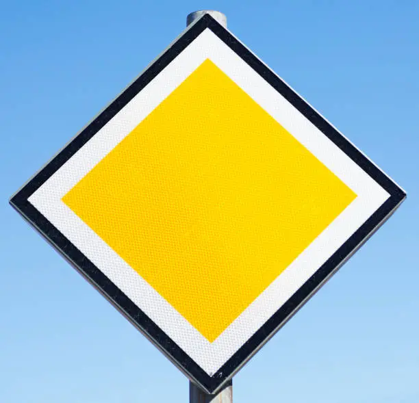traffic sign meaning main road, in white, yellow and black