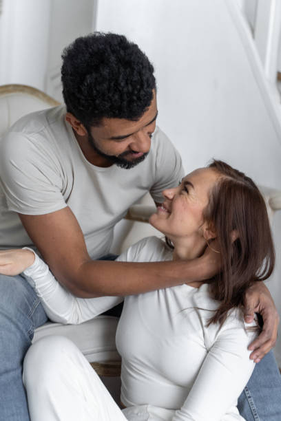istock Multiethnic American couple embracing at home. 1494583066