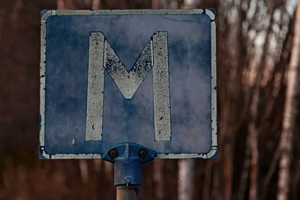 traffic sign with a capital M which means meeting place
