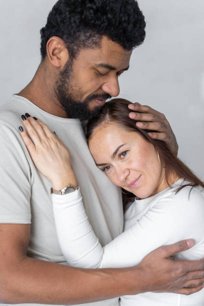 istock Multiethnic couple embracing at home. 1494583735