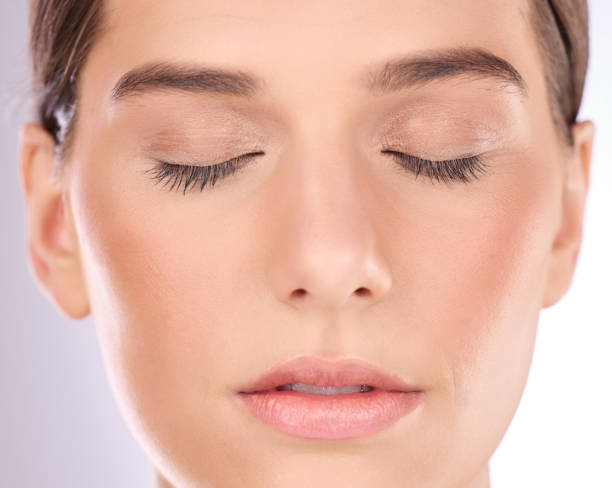 istock Woman, face and eyes closed for makeup, cosmetics and  laser transformation on studio background. Closeup female model, facial aesthetic and skincare of botox, beauty glow and chemical peel results 1494583806