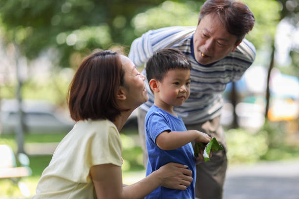istock Son enjoying refreshments with parents in the park 1494584450