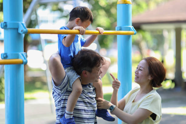 istock Son and parents playing outside the park 1494584522