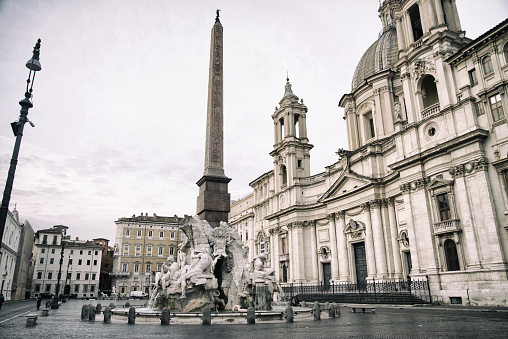 Fountain of the Four Rivers by Bernini in 1651, Egyptian Obelisk and Sant Agnese Church on the famous Piazza Navona, Rome, Italy. Toned Image.