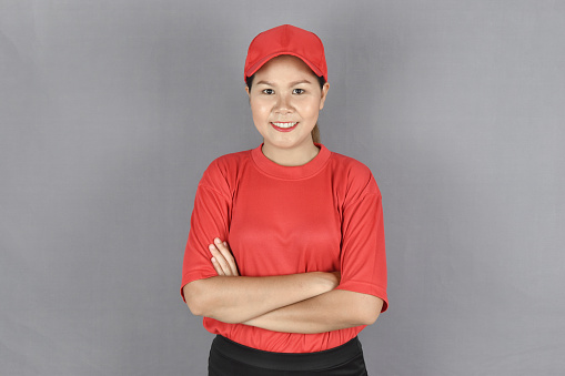 Young delivery woman happy face smiling with crossed arms looking at the camera. Positive person.