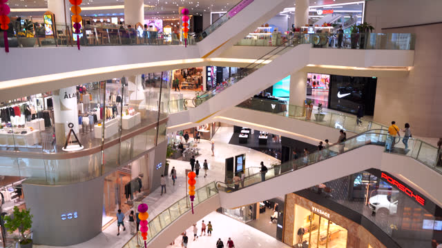 Many people walking and shopping in shopping mall
