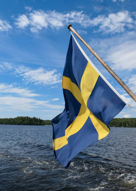 Low angle view of flag against blue sky