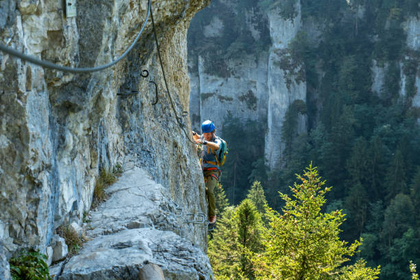 istock Distant view of climber on Via Ferrata, spectacular rock face 1494589060