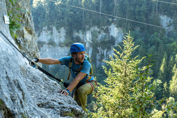 istock Climber clambering on rock, Via Ferrata 1494589829