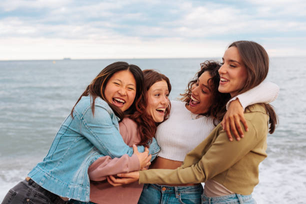 istock Reunited young women hugging on beach 1494590275