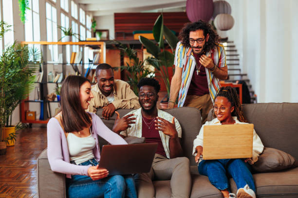 istock Multiracial friend group talking on couch in living room. 1494591631