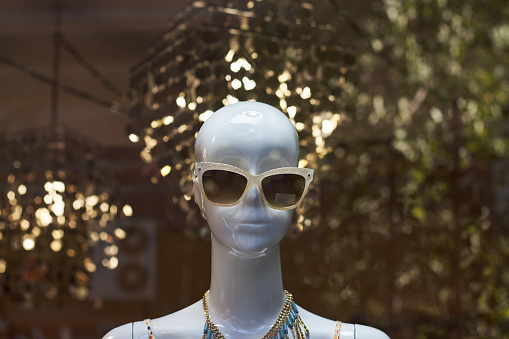 mannequin with sunglasses and blurred background