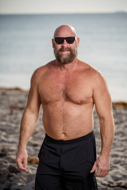 istock Tough man with beard on the beach 1494596345