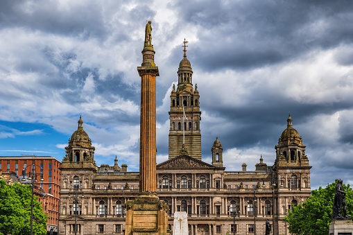 City Chambers and Scott Monument at George Square in Glasgow, Scotland, United Kingdom.