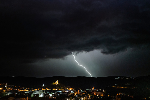 Dark thunderstorm over the city at night