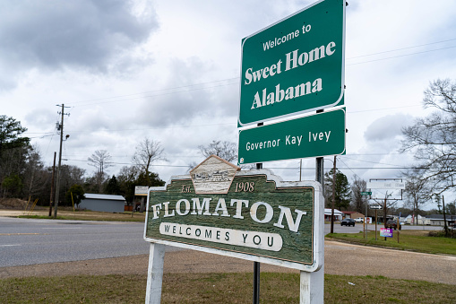 Signs welcome travelers across the Alabama state line and into the city of Flomaton.