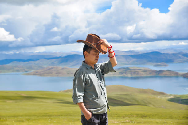 cowboy style hat straw hat with black ribbon isolated on white background, straw hat for women and men head protection