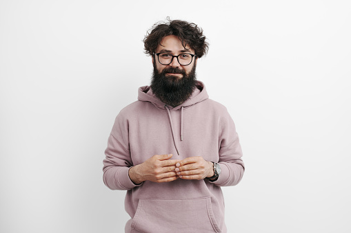 Portrait of handsome man isolated white background, wearing pink hoodie. High quality photo