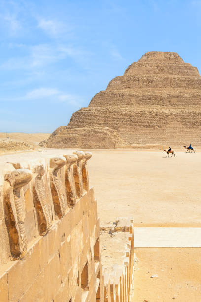 istock Men Riding Camels At The Step Pyramid, Sakkara, Egypt 1494602858
