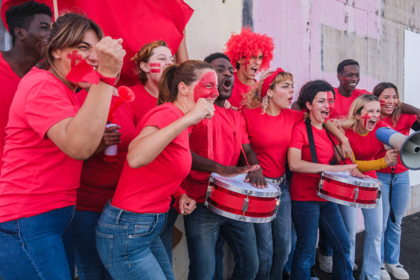 istock Large group of fans from different backgrounds and classes together cheering for their team during the competition 1494603074