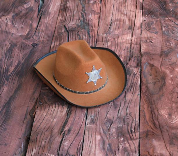 istock cowboy sheriff hat on wooden background 1494603685