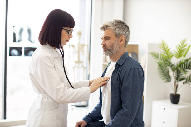 istock GP using stethoscope during patient's checkup in exam room 1494605927