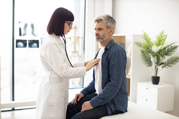 istock GP using stethoscope during patient's checkup in exam room 1494605941