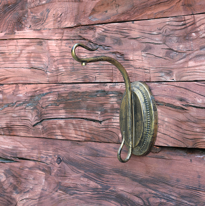 bronze clothes hook on wooden wall